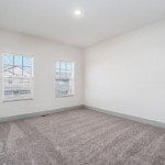 Carpeted bedroom with recess lighting