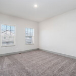 Carpeted bedroom with recess lighting