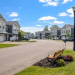 bench and road leading to townhomes